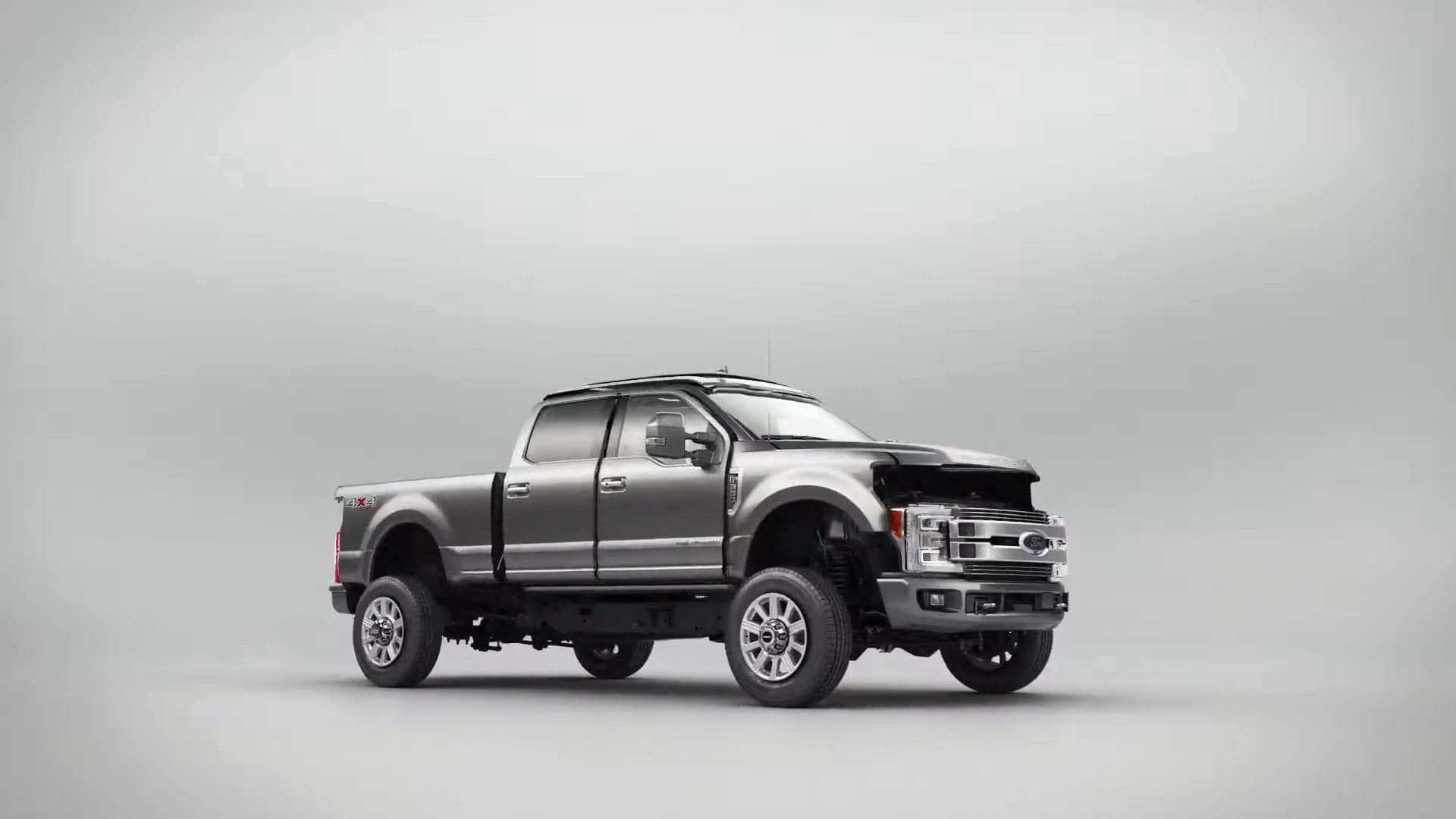 Silver pickup truck rendered in a white studio before the exploded-view sequence