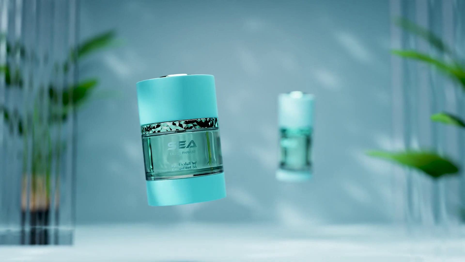 Two turquoise product containers floating among green leaves in a bright studio